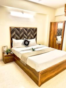 a bedroom with a large bed in a room at Breezy Brown Spacious 2 BHK Lake View in Mumbai