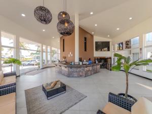 a living room with a fireplace and a lobby at Bosque do Porto Praia Hotel in Porto Seguro