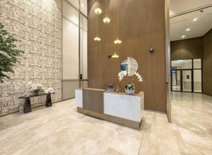 a lobby with a reception desk and a brick wall at Luxury 2BR Sea Burj views Khalifa infinity pool in Dubai +67 photos