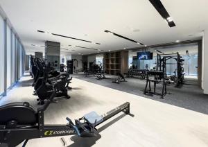 a gym with treadmills and exercise equipment in a building at Luxury 2BR Sea Burj views Khalifa infinity pool in Dubai