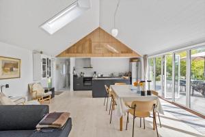 a kitchen and living room with a table and chairs at 6798-Allinge-Aeblebakken-9 in Allinge