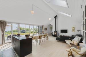 a living room with a table and a dining room at 6798-Allinge-Aeblebakken-9 in Allinge