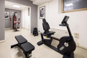 a gym with two treadmills and two ellipticals at Holiday Inn Genoa City by IHG in Genoa