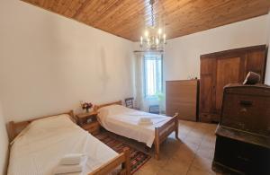 a bedroom with a bed and a table in it at Characterful 2-Bed Home in Peaceful Town Near Agios Nikolaos in Neápolis