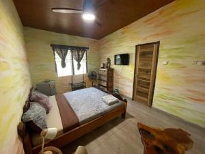 a bedroom with a bed and a wooden wall at Sango beach in Accra