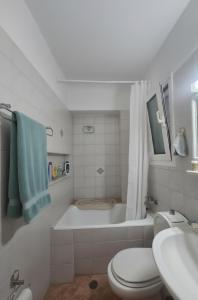 a bathroom with a tub and a toilet and a sink at Characterful 2-Bed Home in Peaceful Town Near Agios Nikolaos in Neápolis +49 photos