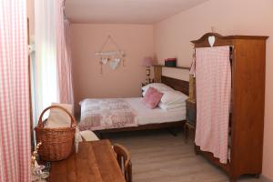 a small bedroom with a bed and a table at B&B Friedau in Nottwil