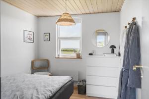a bedroom with a bed and a sink and a mirror at G421-Lemvig-Gyvelvej-21 in Lemvig