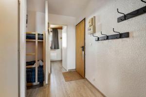 a hallway with a room with bunk beds at Ski-in Chalet-Style View Flat - Résidence les Eterlous in Val Thorens