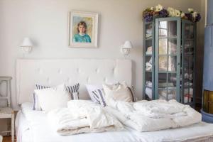 a bedroom with a white bed with pillows at STO754-Graeddoe-Maroe-1 in Gräsken