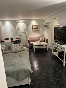 a living room with two beds and a couch at Leilighet i hus in Sarpsborg