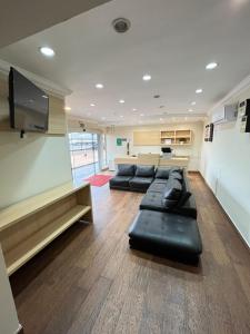 a waiting room with couches and a flat screen tv at Hotel Inter Alexandria in Cândido Mota