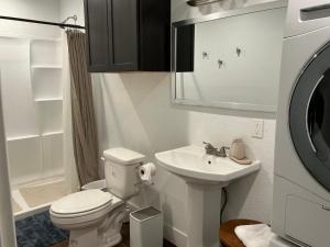 a white bathroom with a toilet and a sink at Cabin in the Woods in San Marcos +9 photos