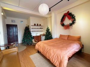 a bedroom with a bed and two christmas trees at Thanh's Homestay in Ấp Bình Thới