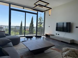 a living room with a couch and a large window at Chic & Cozy Designer Space 1A in Addis Ababa