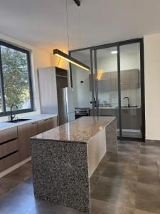 a kitchen with a island in the middle of a room at Chic & Cozy Designer Space 1A in Addis Ababa