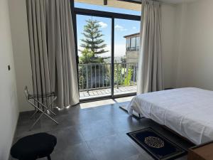 a bedroom with a bed and a large window at Chic & Cozy Designer Space 1A in Addis Ababa