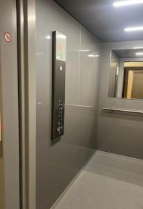 a elevator in a bathroom with a sign on the wall at 3 izbový byt KNM in Kysucké Nové Mesto