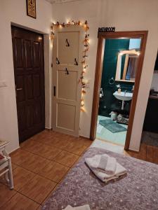 a room with a bathroom with a door and a sink at Domus Foresta Apartmani in Brdo +40 photos