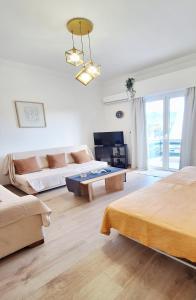a large living room with a couch and a table at Best View Katechaki Bridge Metro in Athens