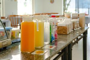 a counter with several bottles of orange juice on it at VELINN Hotel Guarda Mor in São Sebastião