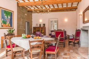 a dining room with a table and chairs at Dimora Vecchio Duomo - Together in Tuscany in Cortona +35 photos