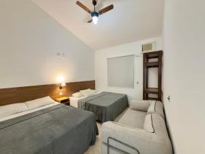 En eller flere senge i et værelse på Juquehy Studios 6 + 15 billeder