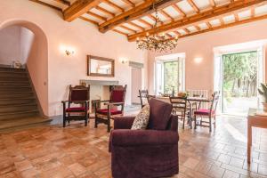 a living room with a table and chairs at Dimora Vecchio Duomo - Together in Tuscany in Cortona