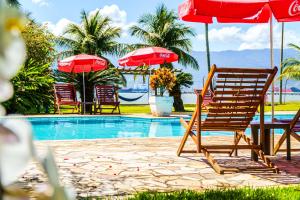 a group of chairs and umbrellas next to a pool at VELINN Hotel Guarda Mor in São Sebastião +30 photos