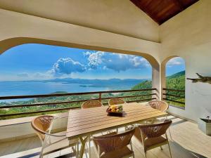 une table et des chaises sur un balcon avec vue dans l'établissement Elysian Hill Villa with private pool by DadoVillas, à Spartýlas