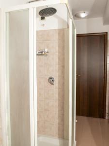 a shower with a glass door in a bathroom at Casa Piazza Garibaldi in Sulmona