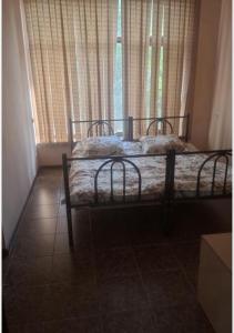 a bedroom with two beds in front of a window at Anissa in Shymkent