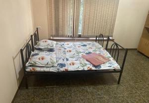 a bedroom with a bed with a floral comforter at Anissa in Shymkent +7 photos