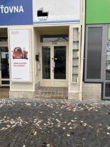 a building with a sign for a car in the window at Apartment Otakar in Nymburk