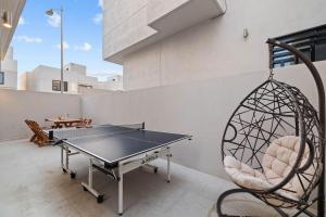a patio with a ping pong table and a swing at Playas de Tijuana in Tijuana