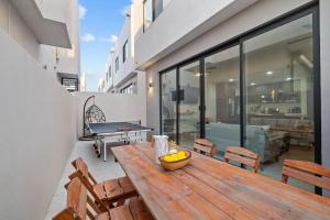 a wooden table with a bowl of fruit on a balcony at Playas de Tijuana in Tijuana