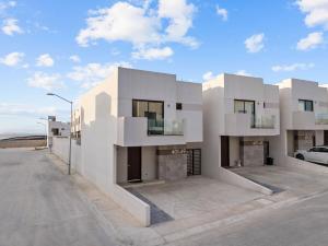 a large white building with a parking lot at Playas de Tijuana in Tijuana