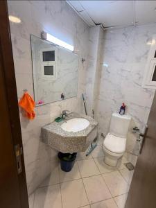 a bathroom with a sink and a toilet at الريامي 4 in Sharjah