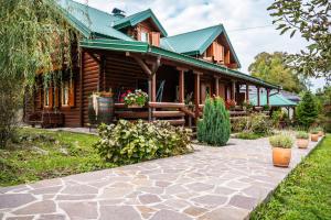 a log house with a walkway in front of it at Brvnara Moj san - Log cabin My Dream in Zelin Mrzlovodički