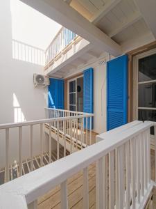 a balcony of a house with blue doors at Casa Albacora in Sal Rei +14 photos
