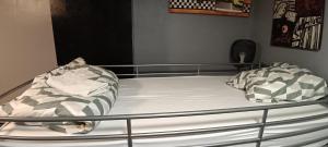 a bed with two pillows on top of it at Lit en dortoir pour homme chez l'habitant au Kremlin-Bicêtre in Le Kremlin-Bicêtre +21 photos