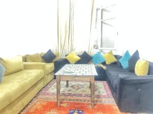 a living room with a couch and a table at Agdal apart in Rabat