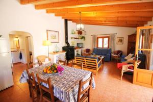 a kitchen and living room with a table with fruit on it at Casa Eva in Fornalutx