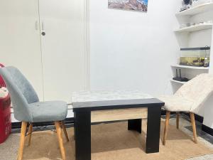 a table and two chairs in a room at Agdal apart in Rabat
