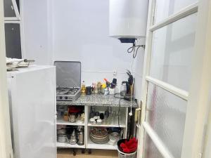 a small kitchen with a stove and a refrigerator at Agdal apart in Rabat