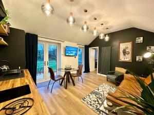 a living room with a table and a couch at The Annexe in Yeovil Junction