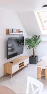 a living room with a tv and a wooden coffee table at APARTAMENTY z GÓRSKIM KLIMATEM in Duszniki Zdrój +51 photos