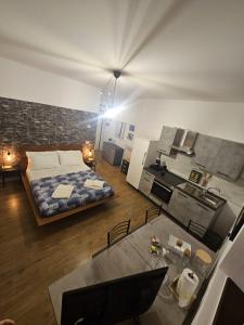 a large room with a bed and a kitchen in it at A due passi dal centro in Castelfidardo +13 photos