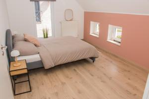 a bedroom with a bed and a wooden floor at Green& Light House16 in Kettenis
