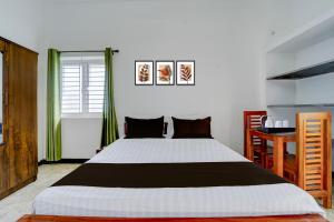 Ένα ή περισσότερα κρεβάτια σε δωμάτιο στο Hotel O Muthalipalayam Bus Stand Coimbatore Formerly Haven Stays